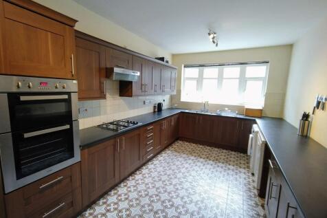 Bright, well-equipped galley kitchen with a lon...
