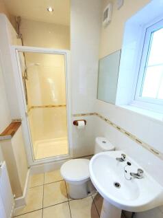 Bright, clean bathroom with a shower cubicle, p...