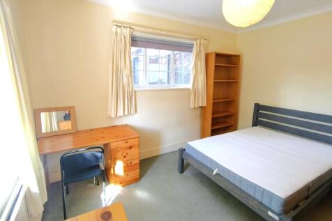 Bright, simply furnished bedroom with a double ...
