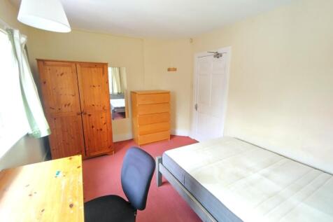 Bright, simply furnished bedroom with a single ...