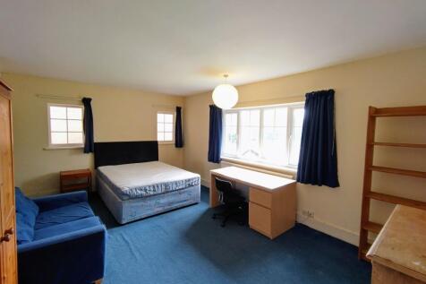 Spacious bright bedroom with a large window, st...