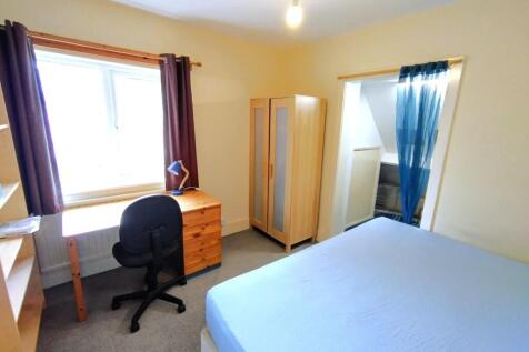 Bright, neatly presented bedroom with a large w...