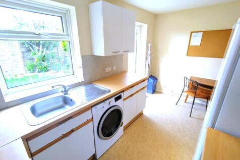Bright galley-style kitchen with a large window...