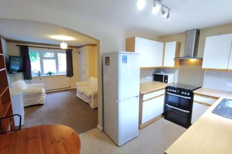 Bright open-plan kitchen and living area with m...