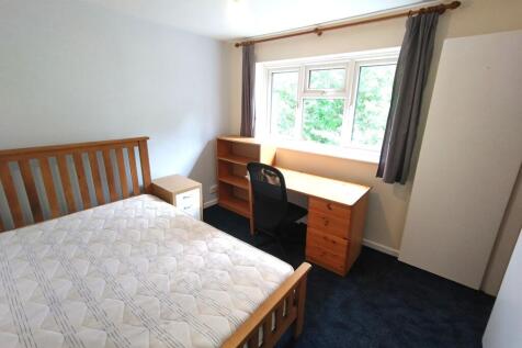 Bright furnished bedroom with a wooden double b...