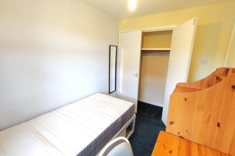 Bright, simply furnished single bedroom with a ...