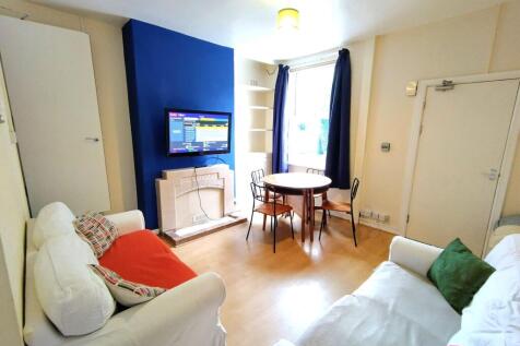 Bright, neatly presented living room with two c...