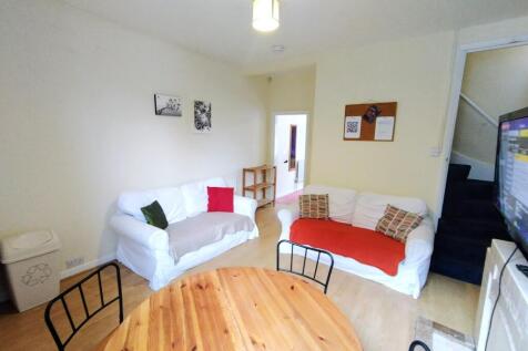 Bright, neutrally decorated living room with tw...