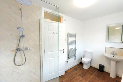 Bright, modern bathroom with a walk-in shower, ...