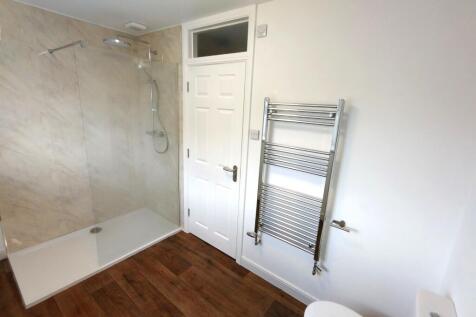 Bright modern bathroom with a large walk-in sho...