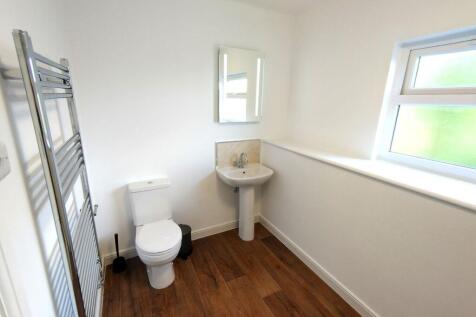 Bright, modern bathroom with a white toilet and...