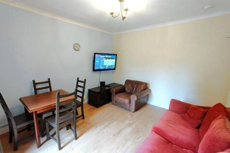 Bright furnished living room with a red sofa, l...