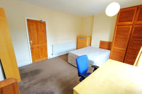 Bright, neutrally decorated double bedroom with...