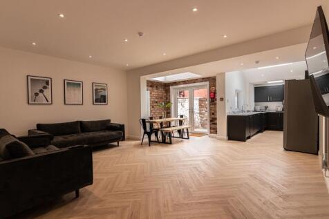 Stylish open-plan living and dining area with c...