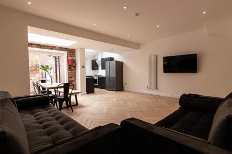 Bright, modern open-plan living area with a sty...