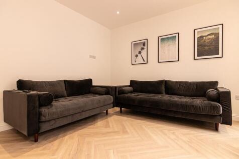 Contemporary corner living area with two matchi...