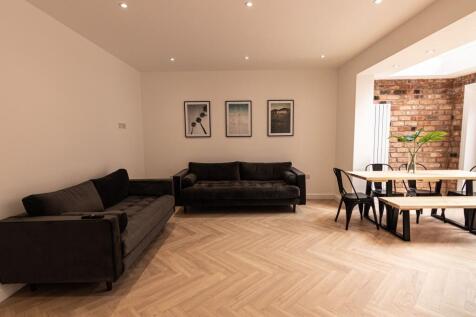 Modern open-plan living and dining area with tw...