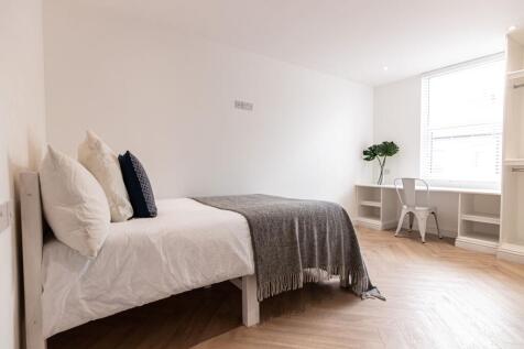 Bright, neatly styled bedroom with a double bed...