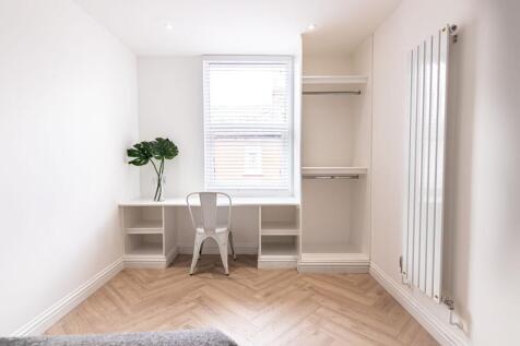 Bright, freshly decorated bedroom with a built-...