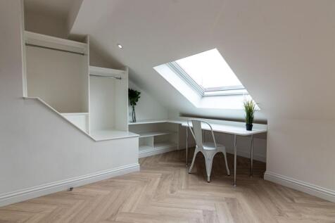 Bright attic bedroom with a large skylight, bui...