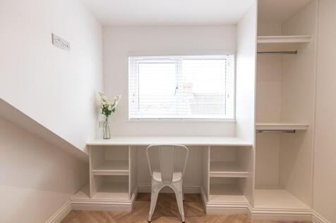 Bright, neatly finished study area with a built...