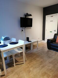 Bright, modern living area with wood-effect flo...