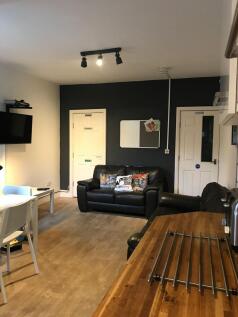 Bright, modern communal lounge with comfortable...