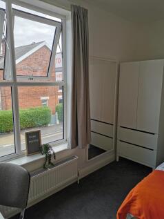 Bright upstairs single bedroom with a large sas...