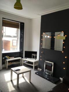 Bright, modern living room with a feature dark-...