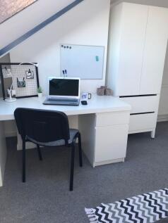Bright, neatly organised study nook with a whit...