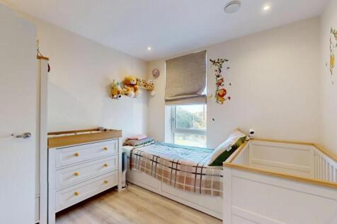 A bright and tidy master bedroom featuring a sp...