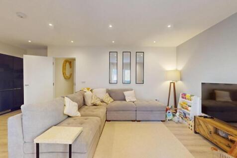 A spacious and modern living room featuring a l...