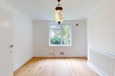 Bright and airy master bedroom featuring a larg...
