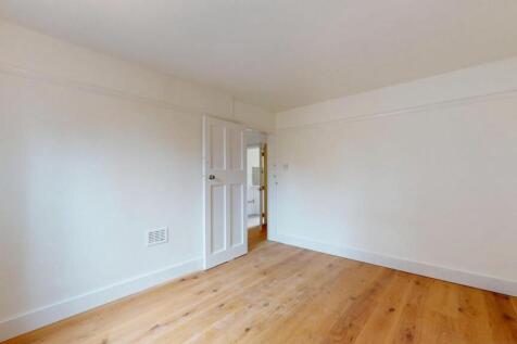 A spacious, well-maintained master bedroom feat...