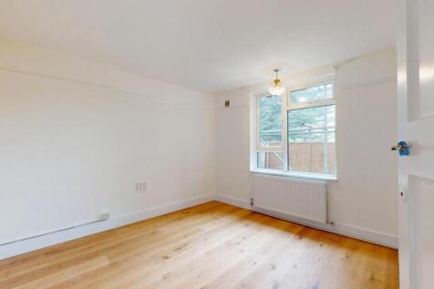 Bright and spacious living area with large wind...
