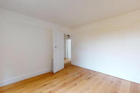 A bright and spacious living room with wooden f...