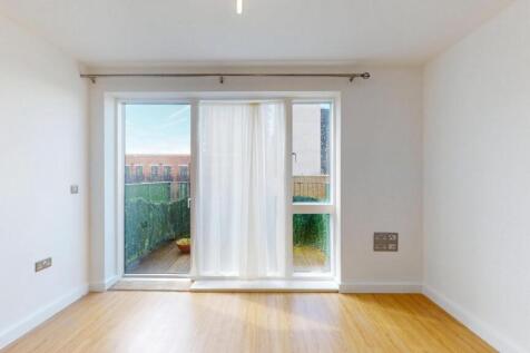 Bright and airy living room featuring large gla...