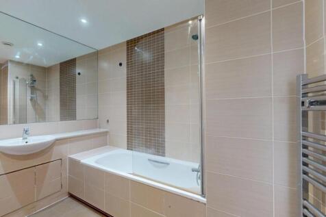 A modern and pristine bathroom featuring a spac...