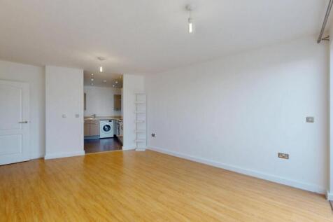 Bright and spacious living room featuring warm ...