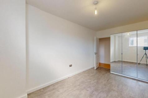 A bright and clean double bedroom featuring a l...