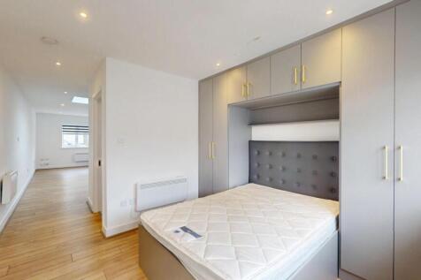 Bright, modern double bedroom with built-in war...