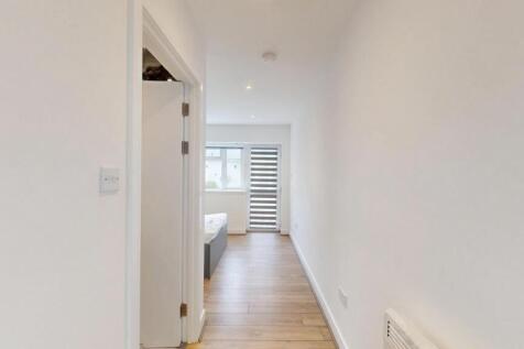 Bright, modern hallway with wood-effect floorin...