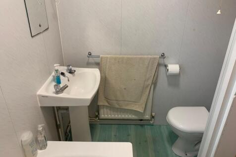 Compact, tidy bathroom with a pedestal sink, WC...