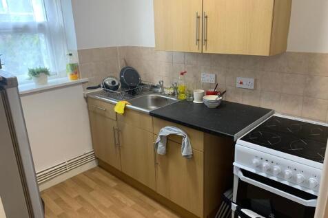 Bright, neatly kept kitchen with a window, lami...