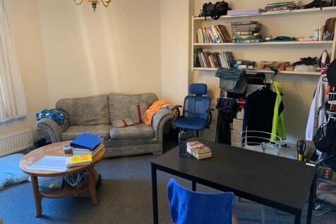 Bright communal living room with a comfortable ...