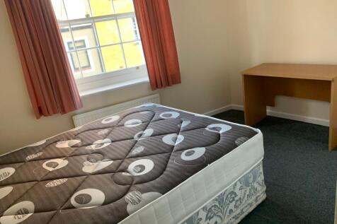 Bright, simply furnished bedroom with a large s...