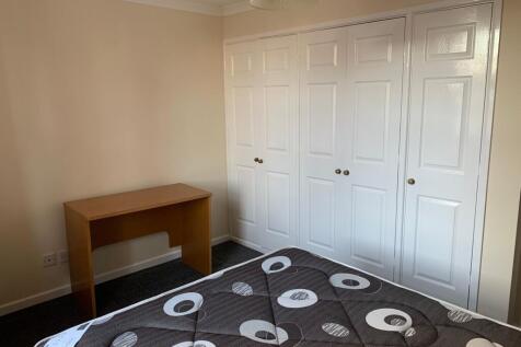 Bright, neatly presented bedroom with built-in ...