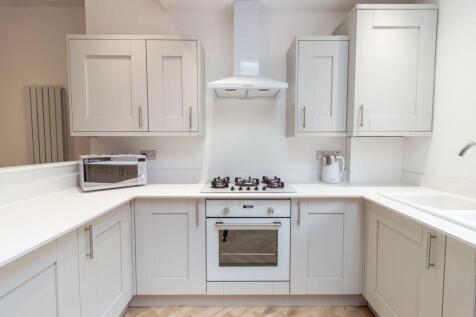 Bright, modern kitchen with white shaker cabine...