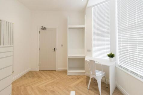 Bright, freshly finished bedroom with pale wood...