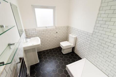 Bright, modern bathroom with white subway tiles...